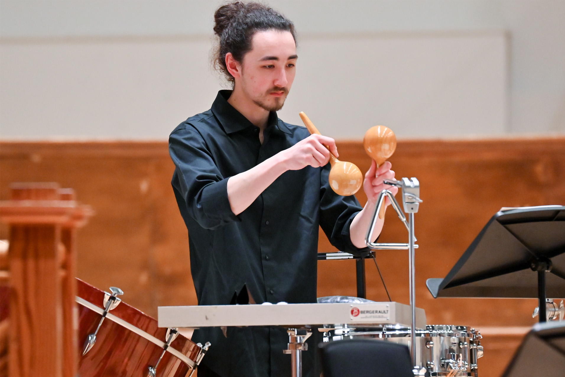 A student playing the triangle in the percussion section of the RCM Philharmonic.